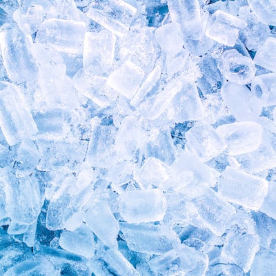 Shattered ice cubes in shades of blue and white, creating a textured background perfect for winter or cold-themed visuals.